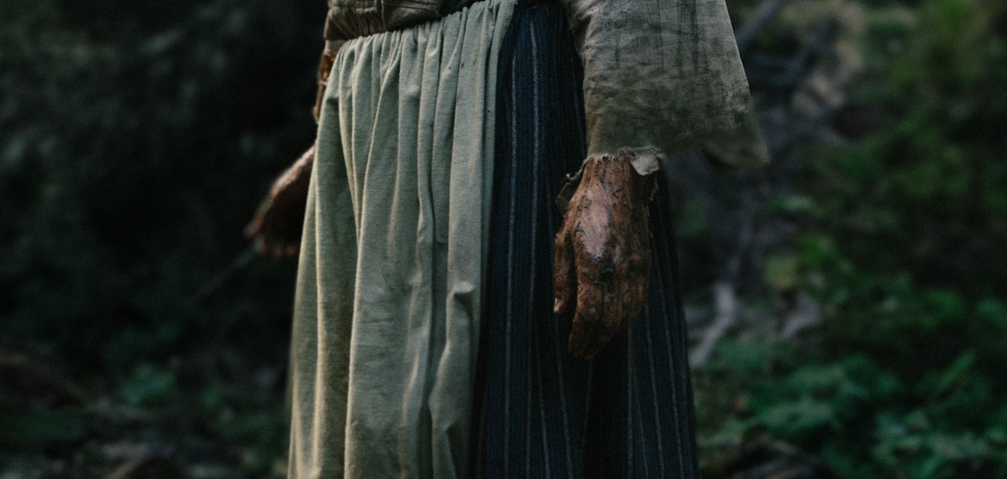 Detail of her hands and skirt
