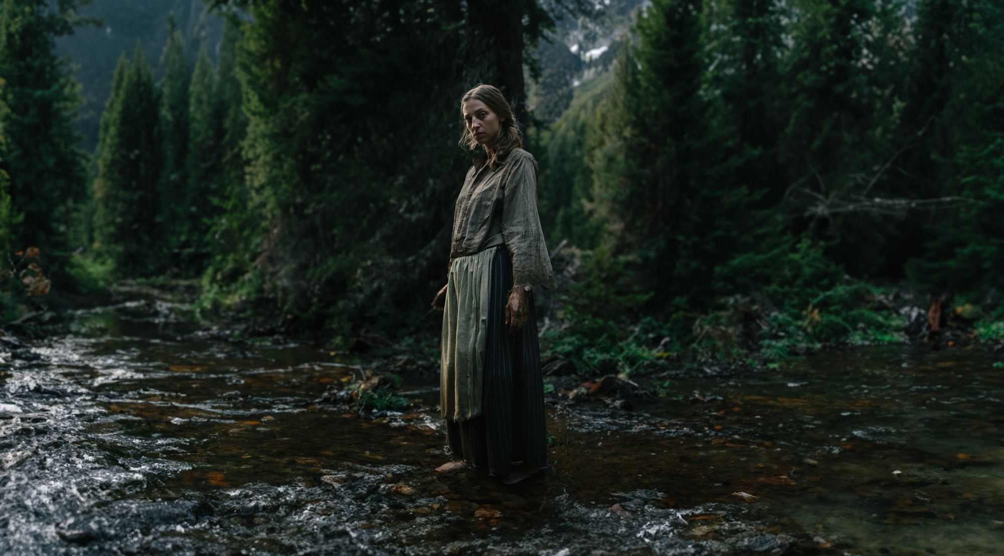 The woman standing in the riverbed, looking back